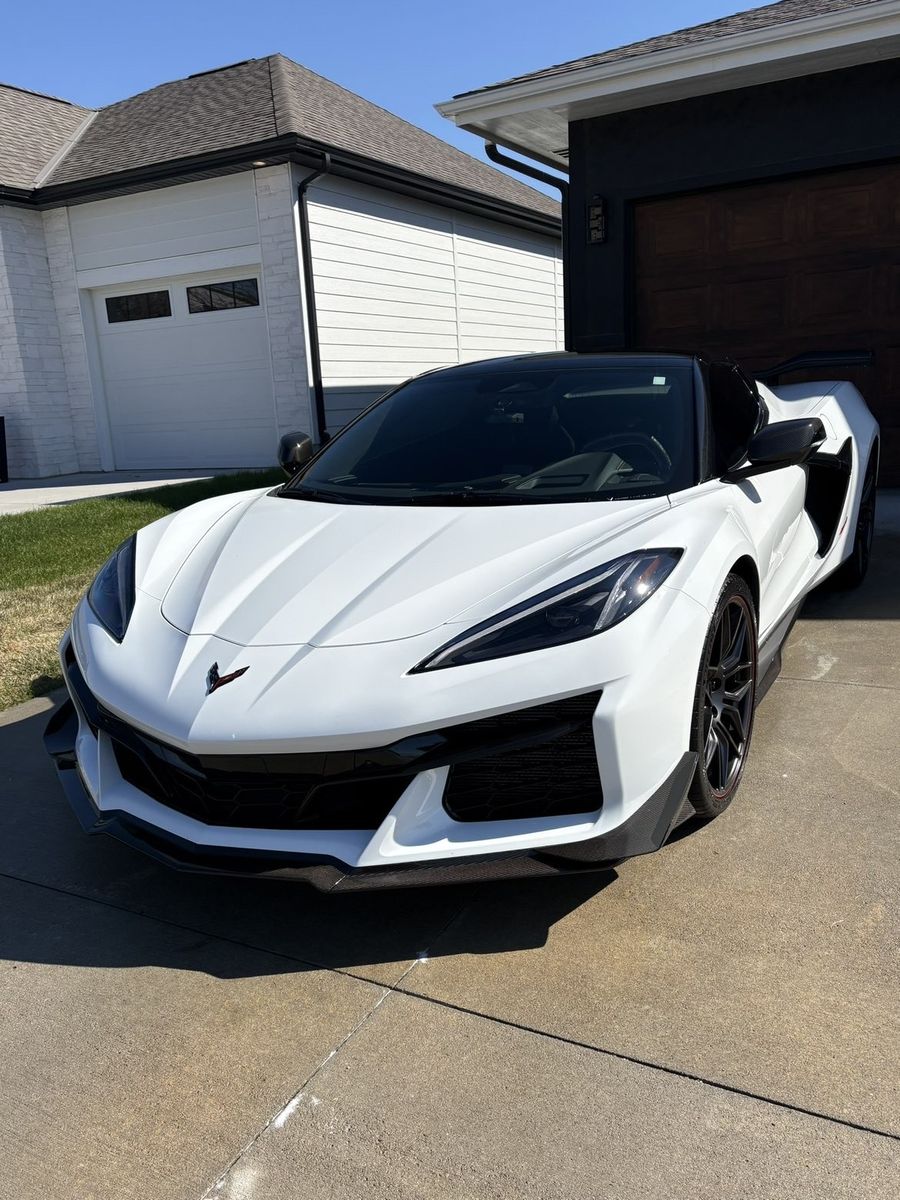 White Chevrolet Corvette C8 Z06 detailed, front 3/4 view in driveway