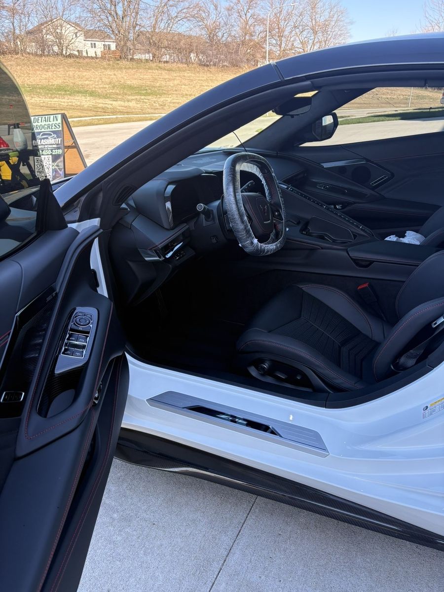 Corvette Z06 interior with DeLashmutt Detailing 'Detail in Progress' sign visible