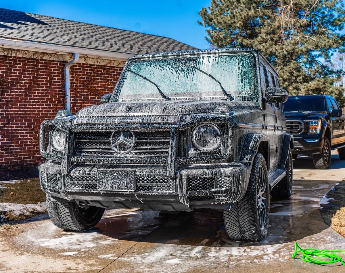 Black Mercedes G550 covered in foam during pre-wash