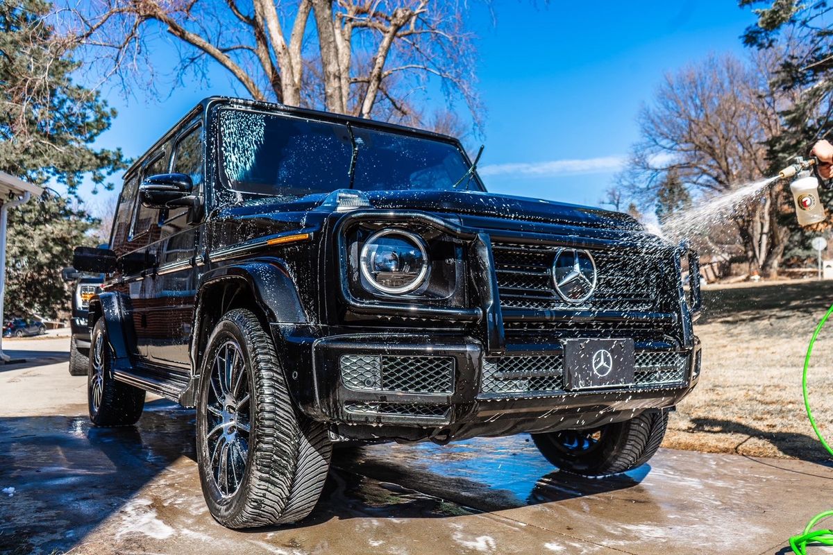Black G-Wagon being rinsed with foam cannon spray