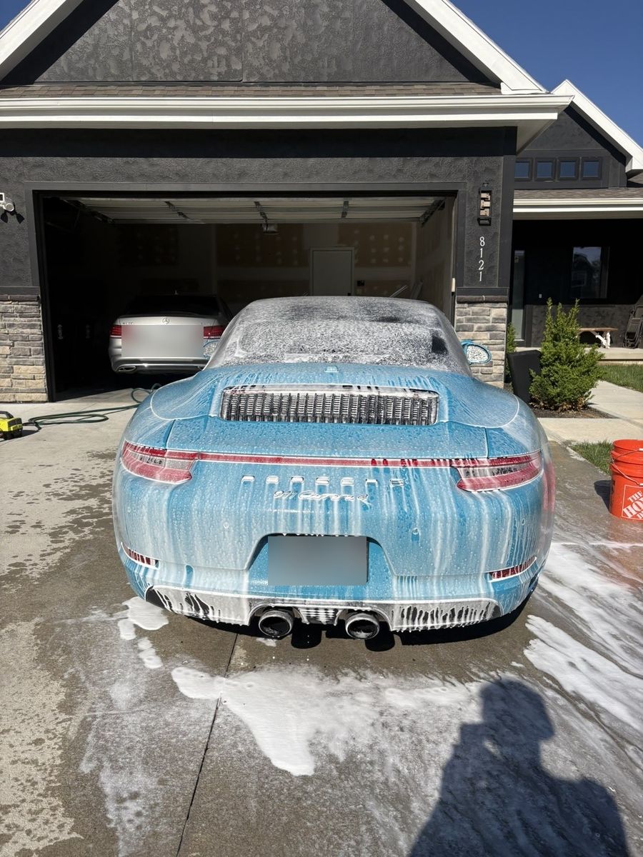 Porsche 911 Carrera covered in foam during the wash