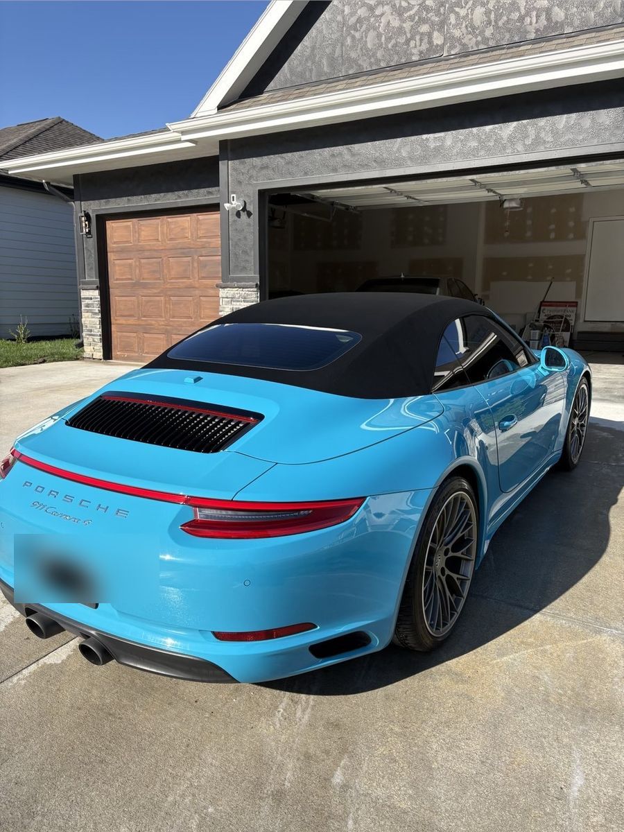 Porsche 911 Carrera covered in foam during the wash